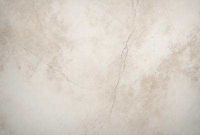 The primary subject of the image is a white wall with a cracked and chipped surface. The setting is a room with a white color scheme. The visual style is a close-up of the wall, showcasing its texture and imperfections. The colors and mood of the image are predominantly white, giving it a clean and minimalist appearance.