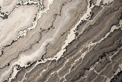 The image features a marble countertop with a unique, swirling pattern. The countertop appears to be a part of a kitchen or bathroom setting. The visual style of the image is a close-up of the marble countertop, showcasing its intricate design. The colors and mood of the image are predominantly dark, with the marble countertop being the main focus.