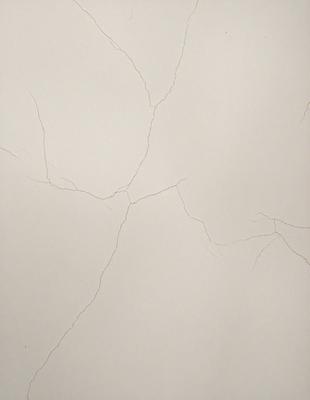 The primary subject of the image is a white wall with visible cracks and peeling paint. The setting is a room with a white wall as the main focus. The visual style is a close-up of the wall, showcasing the cracks and peeling paint. The colors and mood of the image are predominantly white, with a slightly aged and worn appearance due to the cracks and peeling paint.