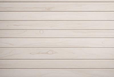 The primary subject of the image is a wooden wall with a unique texture. The setting is a room with a white wall, and the visual style appears to be a combination of a photo and a drawing. The colors and mood of the image are predominantly white, giving it a clean and minimalist appearance.