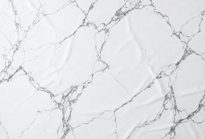 The primary subject of the image is a white marble wall with a pattern of holes. The setting is a room with a white marble floor. The visual style is a close-up of the marble wall, showcasing its unique texture and pattern. The colors and mood of the image are predominantly white, giving it a clean and elegant appearance.