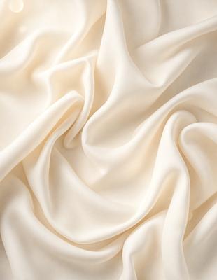 The primary subject of the image is a white sheet of fabric, which is the main object, scene, or focus of the image. The setting is a white background, which provides a clean and minimalistic environment. The visual style is a close-up of the fabric, showcasing its texture and details. The colors and mood of the image are predominantly white, giving it a clean, serene, and elegant appearance.