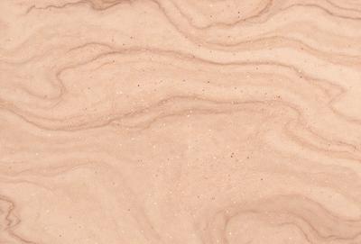 The primary subject of the image is a close-up of a sandy surface with a pattern of glittering specks. The setting is a beach or a sandy environment, and the visual style appears to be a photo or a digital artwork. The colors and mood of the image are predominantly warm and inviting, with the glittering specks adding a touch of sparkle and interest to the scene.