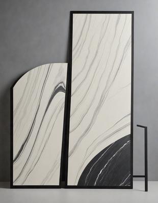 The primary subject of the image is a pair of marble-like columns, which are the main objects in the scene. The setting is a gray background, which provides a neutral and clean environment for the columns. The visual style of the image is a combination of photo and digital art, as it appears to be a photograph of a digital art piece. The colors and mood of the image are predominantly black and white, giving it a classic and elegant appearance.