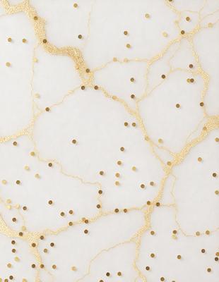 The primary subject of the image is a pattern of gold dots on a white background. The setting appears to be a white wall, and the visual style is a combination of digital art and illustration. The dominant colors are white and gold, creating a clean and elegant atmosphere.