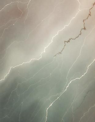 The primary subject of the image is a marble countertop with a lightning bolt pattern. The setting is a kitchen, and the visual style is a photo. The countertop has a blue and white color scheme, giving it a modern and sophisticated appearance. The lightning bolt pattern adds a unique and eye-catching element to the surface, making it stand out as a focal point in the kitchen.