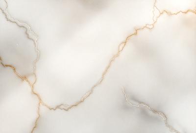 The primary subject of the image is a marble surface with a pattern of gold streaks. The setting is a white background, which contrasts with the marble surface. The visual style is a close-up of the marble surface, showcasing the gold streaks. The colors and mood of the image are predominantly white and gold, creating a sense of elegance and sophistication.
