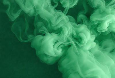 The primary subject of the image is a green, swirling, and misty cloud. The setting is a dark background, which contrasts with the vibrant green color of the cloud. The visual style appears to be a digital art or illustration, as the cloud is depicted in a dynamic and artistic manner. The dominant colors and overall atmosphere of the image are lively and energetic, with the green cloud being the focal point of the scene.