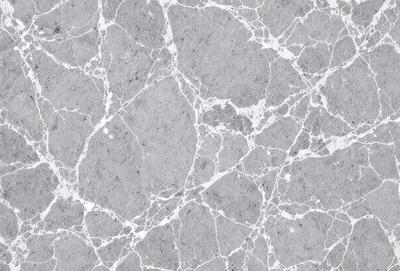 The image features a close-up of a marble wall with a patterned texture. The wall appears to be made of marble, giving it a luxurious and elegant appearance. The pattern on the wall adds visual interest and depth to the scene. The overall atmosphere of the image is sophisticated and refined.