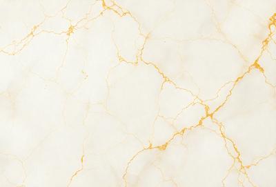 The primary subject of the image is a white marble wall with a gold-colored texture. The setting is a room with a white marble floor. The visual style is a close-up of the marble wall, showcasing its unique texture. The colors and mood of the image are predominantly white and gold, creating a luxurious and elegant atmosphere.