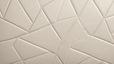 The primary subject of the image is a white wall with a pattern of triangles. The setting is a room with a white surface, and the visual style appears to be a combination of a photo and a pattern. The dominant colors are white and grey, creating a clean and minimalist atmosphere.