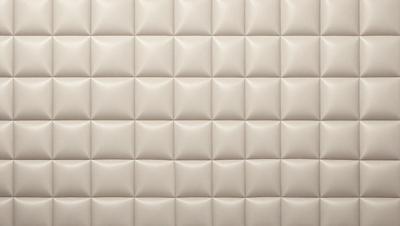 The primary subject of the image is a wall with a pattern of white squares. The setting is a room with a white wall, and the visual style is a close-up of the wall. The dominant colors are white, and the overall atmosphere is clean and minimalistic.