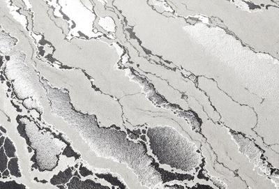 The image features a marble-like surface with a pattern of swirls and waves. The primary subject is the intricate design of the marble, which creates a visually appealing and textured surface. The setting is a room with a white background, which highlights the marble's beauty. The visual style is a close-up of the marble, showcasing its unique pattern and texture. The colors and mood of the image are predominantly white, giving it a clean and elegant appearance.