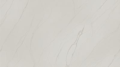 The primary subject of the image is a white marble wall with a pattern of swirls and grooves. The setting is a room with a white marble floor, which complements the wall. The visual style is a close-up of the marble wall, showcasing its intricate design. The colors and mood of the image are predominantly white, giving it a clean and elegant appearance.