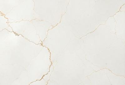 The primary subject of the image is a white marble wall with a gold-colored, cracked surface. The setting is a room with a white marble floor. The visual style is a close-up of the marble wall, showcasing its unique texture and appearance. The colors and mood of the image are predominantly white and gold, giving it a luxurious and elegant feel.