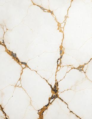 The primary subject of the image is a marble countertop with a gold-like pattern. The setting is a kitchen, and the visual style is a close-up of the marble countertop. The colors and mood of the image are predominantly white and gold, giving it a luxurious and elegant appearance.