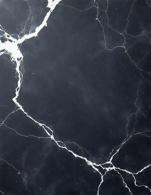 The primary subject of the image is a close-up of a marble surface, possibly a countertop or a wall. The setting is a dark room, which creates a moody atmosphere. The visual style is a black and white photo, giving the image a classic and timeless appearance. The colors and mood are predominantly dark, with the marble surface being the main focal point.