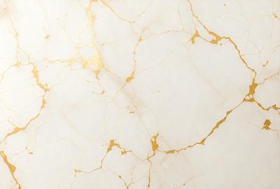 The primary subject of the image is a marble surface with a gold-like pattern. The setting is a white background, which contrasts with the gold and marble. The visual style is a close-up of the marble surface, showcasing its unique texture and pattern. The colors and mood of the image are predominantly white and gold, creating a luxurious and elegant atmosphere.