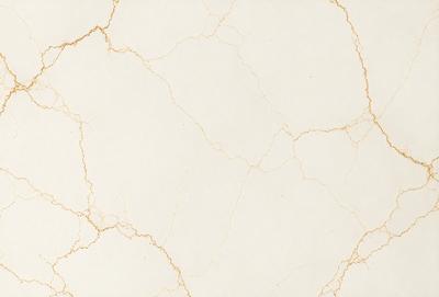 The primary subject of the image is a white marble wall with a gold-colored texture. The setting is a room with a white marble floor. The visual style is a close-up of the marble wall, showcasing its unique texture and color. The colors and mood of the image are predominantly white and gold, creating a luxurious and elegant atmosphere.