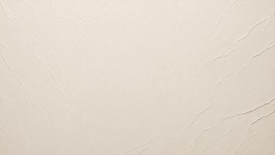 The primary subject of the image is a white wall with a textured surface. The setting is a room with a plain background. The visual style is a close-up of the wall, showcasing its texture. The colors and mood of the image are predominantly white, giving it a clean and minimalist appearance.