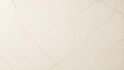 The primary subject of the image is a white wall with a cracked texture. The setting is a room with a white background. The visual style is a close-up of the wall, showcasing the cracked texture. The colors and mood of the image are predominantly white, giving it a clean and minimalist appearance.