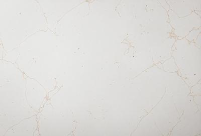 The primary subject of the image is a white marble wall with a pattern of yellow spots. The setting is a room with a white marble floor. The visual style is a close-up of the marble wall, showcasing the unique pattern of yellow spots. The colors and mood of the image are predominantly white and yellow, creating a warm and inviting atmosphere.