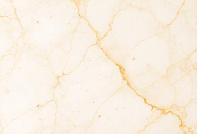 The primary subject of the image is a marble wall with a yellowish tint. The setting is a room with a white marble floor. The visual style is a close-up of the marble wall, showcasing its texture and color. The dominant colors are yellow and white, creating a warm and elegant atmosphere.