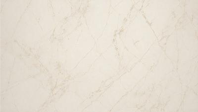 The primary subject of the image is a white marble wall with a pattern of small holes. The setting is a room with a white marble floor. The visual style is a close-up of the marble wall, showcasing its texture and pattern. The colors and mood of the image are predominantly white, giving it a clean and elegant appearance.