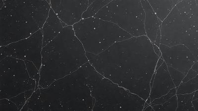 The primary subject of the image is a black marble countertop with a pattern of white stars. The setting is a dark room, and the visual style is a close-up of the marble countertop. The dominant colors are black and white, creating a contrasting and elegant atmosphere.
