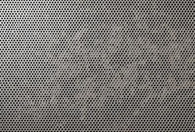 The primary subject of the image is a close-up of a patterned surface, which appears to be a textured wall or a piece of fabric. The setting is indoors, with the patterned surface being the main focus of the image. The visual style is a close-up, which emphasizes the intricate details of the pattern. The colors and mood of the image are predominantly neutral, with the patterned surface being the main source of visual interest.