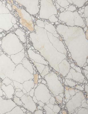 The image features a marble wall with a white and brown color scheme. The wall is covered in a pattern of white and brown marble, giving it a unique and elegant appearance. The marble wall appears to be a part of a larger structure, possibly a building or a monument. The combination of white and brown marble creates a visually appealing and timeless design.