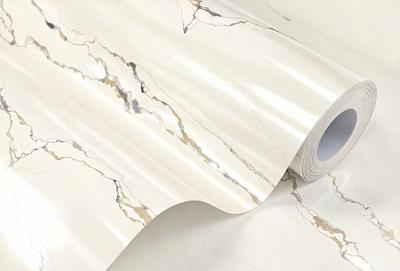 The primary subject of the image is a roll of marble paper. The paper is white and has a marble texture, giving it a luxurious and elegant appearance. The setting is a room with a white background, which helps to emphasize the marble paper's texture and design. The visual style of the image is a close-up, allowing the viewer to appreciate the details of the marble paper. The colors and mood of the image are predominantly white, giving it a clean and sophisticated feel