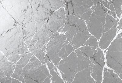 The image features a gray marble wall with a pattern of white and gray veins. The wall appears to be textured and has a unique, natural appearance. The primary subject of the image is the marble wall, which serves as the main focus of the scene. The setting is indoors, likely in a building or a room with a similar design. The visual style of the image is a close-up of the marble wall, showcasing its intricate patterns and textures. The colors and mood of the image