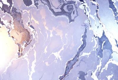 The image features a marbled surface with a mix of gray, white, and black colors. The marbled pattern creates a visually interesting and textured background. The primary subject of the image is a close-up of the marbled surface, showcasing its unique and intricate design. The setting appears to be indoors, possibly in a room with a modern or minimalist aesthetic. The visual style of the image is a close-up, focusing on the details of the marbled surface. The colors and
