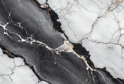 The primary subject of the image is a marble wall with a gold and black pattern. The setting is a room with a white marble surface. The visual style is a close-up of the marble wall, showcasing its intricate design. The dominant colors are gold and black, creating a luxurious and elegant atmosphere.