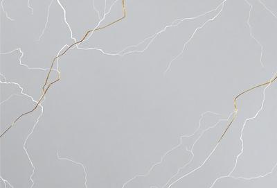 The primary subject of the image is a marble surface with a pattern of gold streaks. The setting is a gray background, which contrasts with the gold streaks. The visual style is a close-up of the marble surface, showcasing the intricate pattern. The colors and mood of the image are predominantly gray and gold, creating a sense of elegance and sophistication.