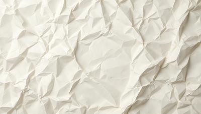 The primary subject of the image is a white paper with a pattern of folded paper. The setting is a white wall, and the visual style is a close-up of the paper pattern. The colors and mood of the image are predominantly white, giving it a clean and minimalist appearance.