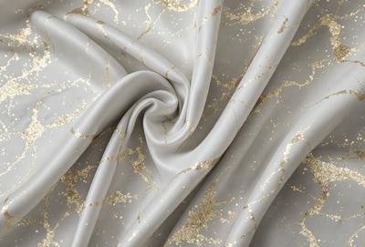 The primary subject of the image is a piece of fabric with a gold and white pattern. The setting is a close-up view of the fabric, showcasing its intricate design. The visual style is a combination of digital art and illustration, creating a unique and eye-catching pattern. The colors and mood of the image are predominantly gold and white, giving it a luxurious and elegant appearance.