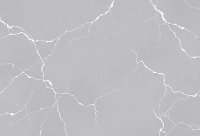 The primary subject of the image is a marble-like surface with a pattern of white and gray. The setting is a gray and white marble wall, which serves as the background. The visual style is a close-up of the marble wall, showcasing its texture and pattern. The colors and mood of the image are predominantly gray and white, giving it a clean and elegant appearance.
