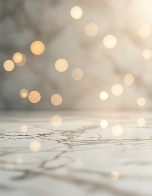 The primary subject of the image is a close-up of a marble table with a pattern of light shining on it. The setting is a room with a white background, and the visual style appears to be a photo. The colors and mood of the image are predominantly white, with the light shining on the marble table creating a bright and clean atmosphere.