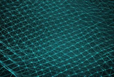 The primary subject of the image is a blue, glowing, and intricate pattern. The setting is a dark background, which contrasts with the bright blue pattern. The visual style is a combination of digital art and illustration, creating a unique and captivating design. The colors and mood of the image are predominantly blue, with a sense of depth and complexity.
