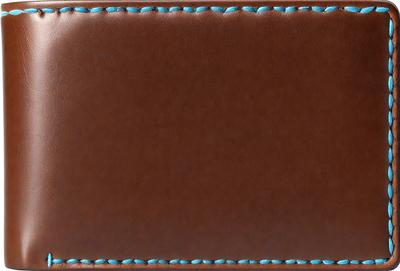The primary subject of the image is a brown leather wallet with a blue stitched border. The wallet is open, revealing a blank interior. The setting is a table, and the visual style is a close-up of the wallet. The colors and mood of the image are warm and earthy, with the brown leather and blue stitching creating a sense of durability and craftsmanship.