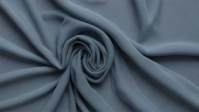 The primary subject of the image is a blue fabric, which appears to be a piece of cloth or a curtain. The setting is a room with a blue background, which complements the blue fabric. The visual style is a close-up of the fabric, showcasing its texture and pattern. The colors and mood of the image are predominantly blue, creating a calm and serene atmosphere.