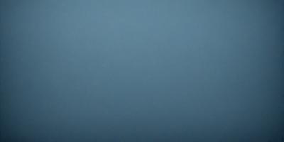The primary subject of the image is a large, empty, and dark blue sky. The setting is a vast, open space with no visible landmarks or objects. The visual style is a natural, untouched, and unaltered representation of the sky. The colors and mood convey a sense of tranquility and vastness.