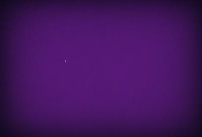 The image features a purple sky with a single star visible in the distance. The star is located towards the left side of the image, and it stands out against the dark purple background. The overall atmosphere of the image is serene and peaceful, with the star being the main focal point.