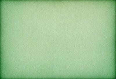 The primary subject of the image is a green background. The setting is a plain, empty space with no visible objects or people. The visual style is a close-up of the green background, which appears to be a pattern or texture. The colors and mood of the image are predominantly green, creating a calm and serene atmosphere.