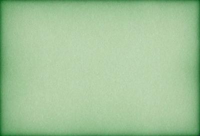 The primary subject of the image is a large, green sheet of paper. The setting is a plain, white background, and the visual style is a close-up of the paper. The colors are predominantly green, and the mood is calm and uncluttered.