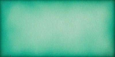 The primary subject of the image is a large, green sheet of paper. The setting is a plain, white background, and the visual style is a close-up of the paper. The colors and mood of the image are predominantly green, giving it a calm and serene atmosphere.