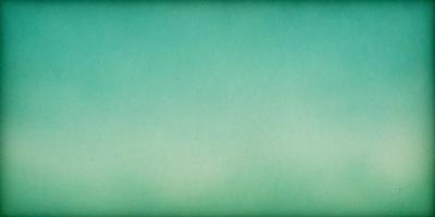 The primary subject of the image is a large, empty, and brightly colored sky. The sky is a vibrant shade of green, which creates a serene and calming atmosphere. The setting is a vast, open space with no visible landmarks or objects, giving the impression of a vast, open area. The visual style of the image is a close-up of the sky, emphasizing its vivid color and expansive nature.