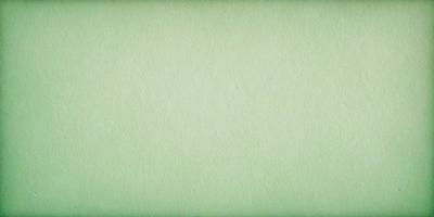 The primary subject of the image is a large, green piece of paper. The setting is a plain, white background, which creates a clean and minimalist visual style. The colors and mood of the image are predominantly green, giving it a calm and serene atmosphere.
